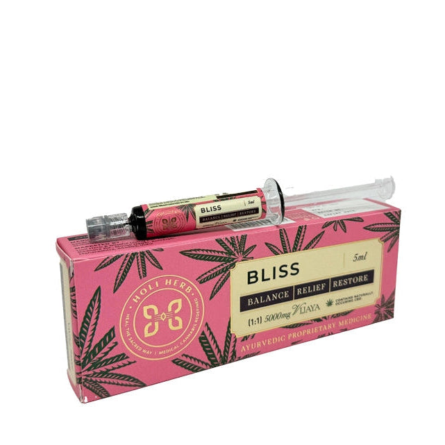 Pink packaging with cannabis leaf design containing two black and gold tubes on a white background