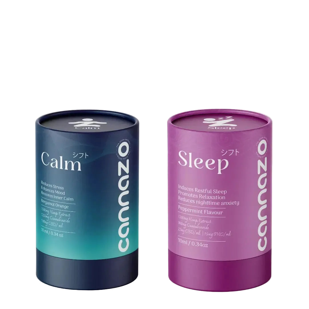 Two cylindrical Cannazo tea tins on a light beige surface with soft shadow overlays. The left tin is dark blue with a teal gradient and labeled 'Calm' with Japanese text 'かンク'.