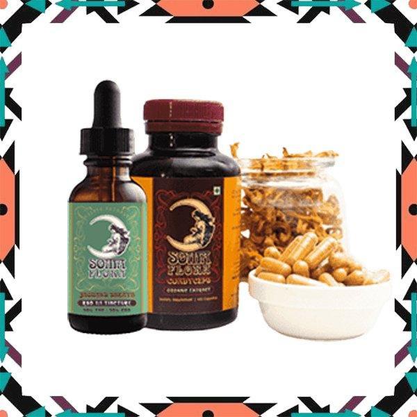 Two Soma Flora supplement bottles alongside a jar of dried mushrooms and a bowl of capsules